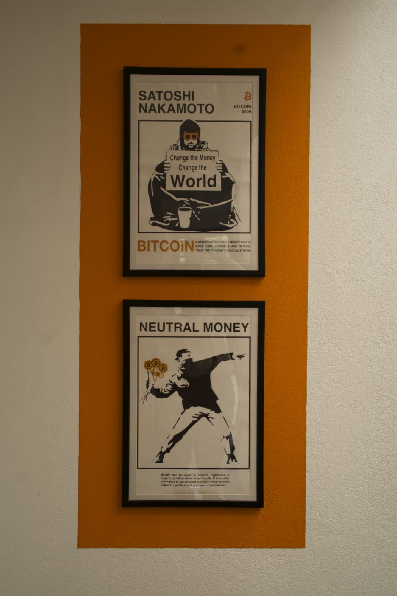 Two Bitcoin posters on an orange stripe: Satoshi Nakamoto, and Neutral money