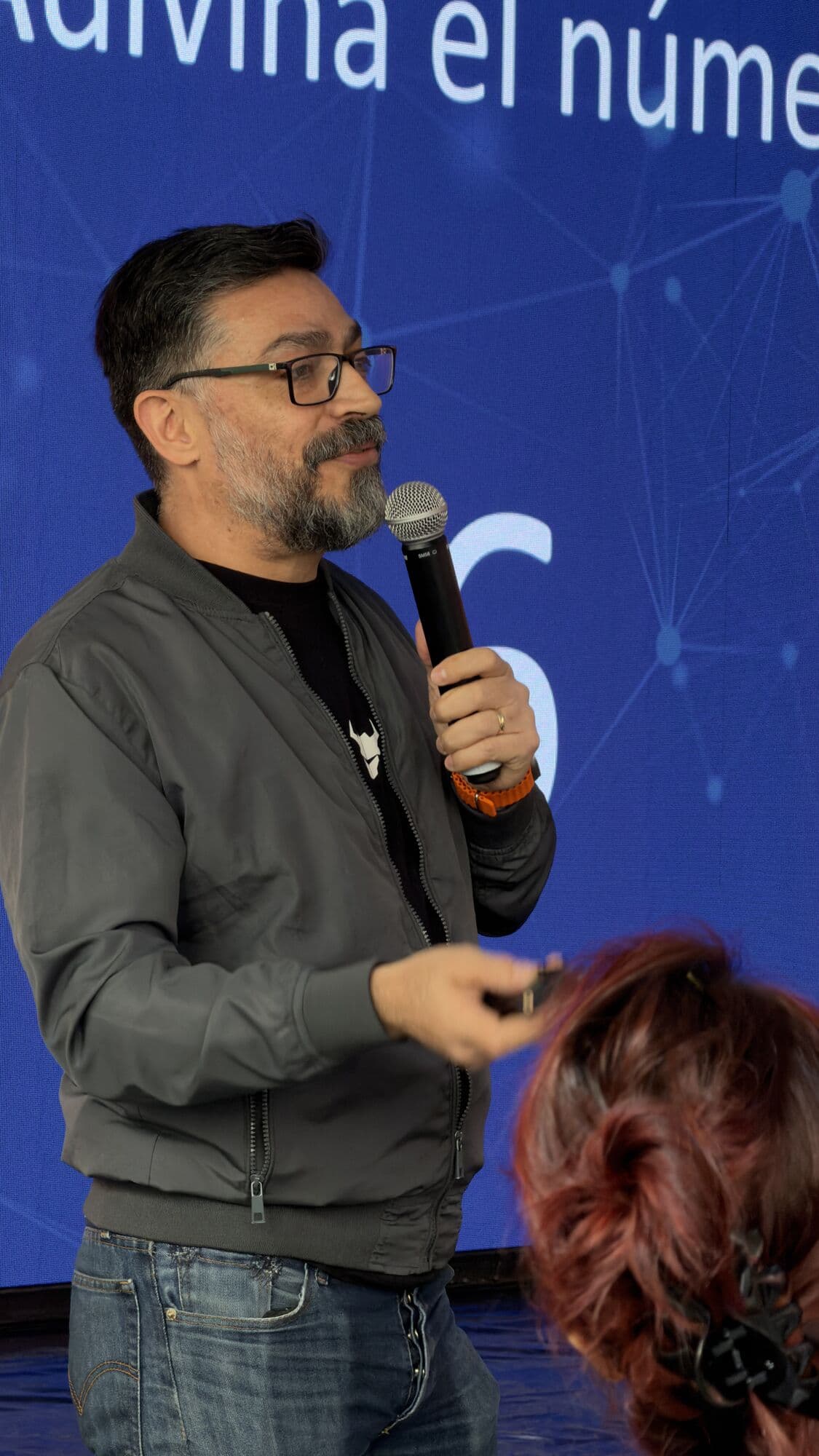 A speaker with a microphone mid-talk